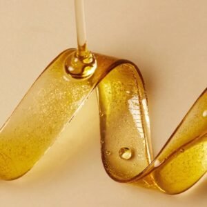 amber facial oil ribbon texture